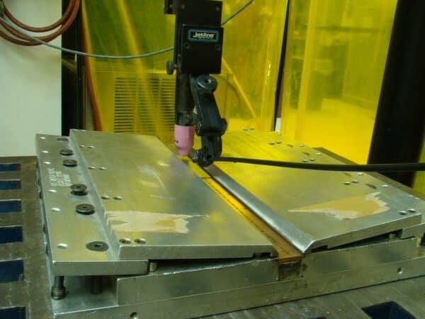 Welding machinery above sheet metal.