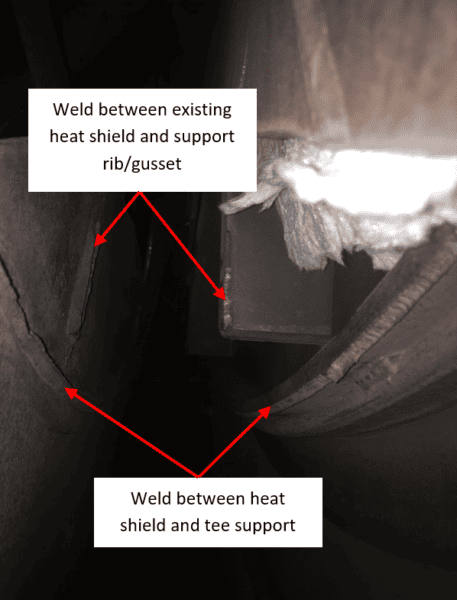 Pieces of metal in the background with the following text "Weld between existing heat shield and support rib/gusset" and "Weld between heat shield and tee support."